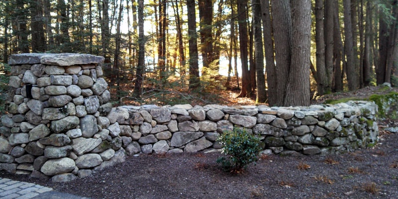 Stone wall with forest path